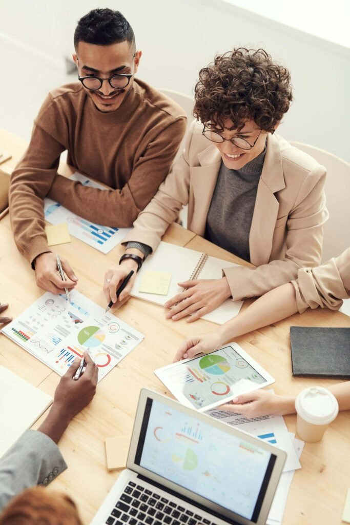 Business consultant explaining analytics dashboard to small business owner