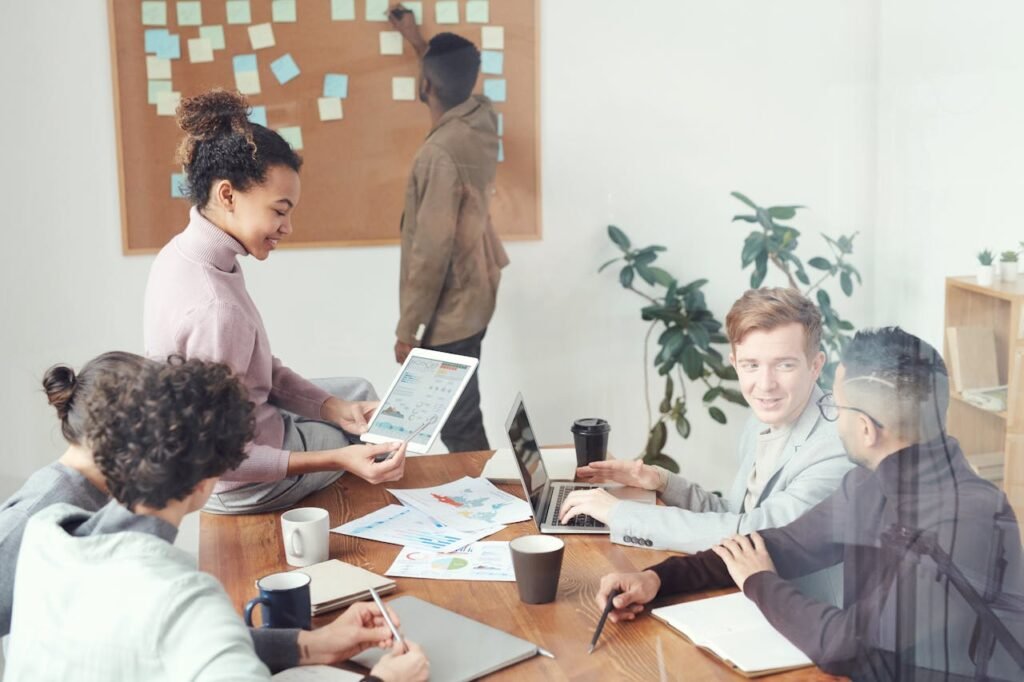 Team of professionals automating spreadsheets together on a laptop
